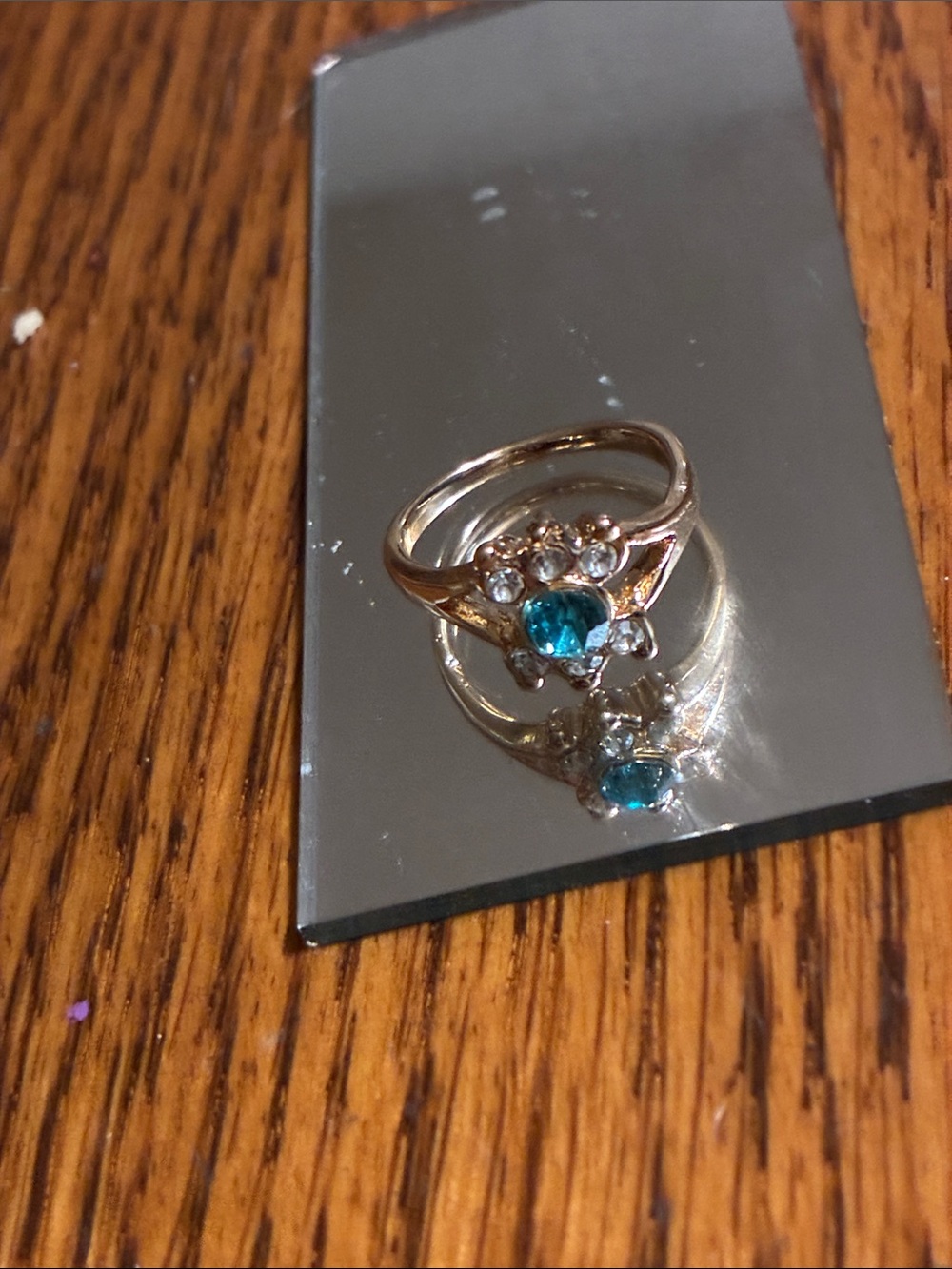 Gold-Tone Ring with Teal Center Stone and Clear Accents
